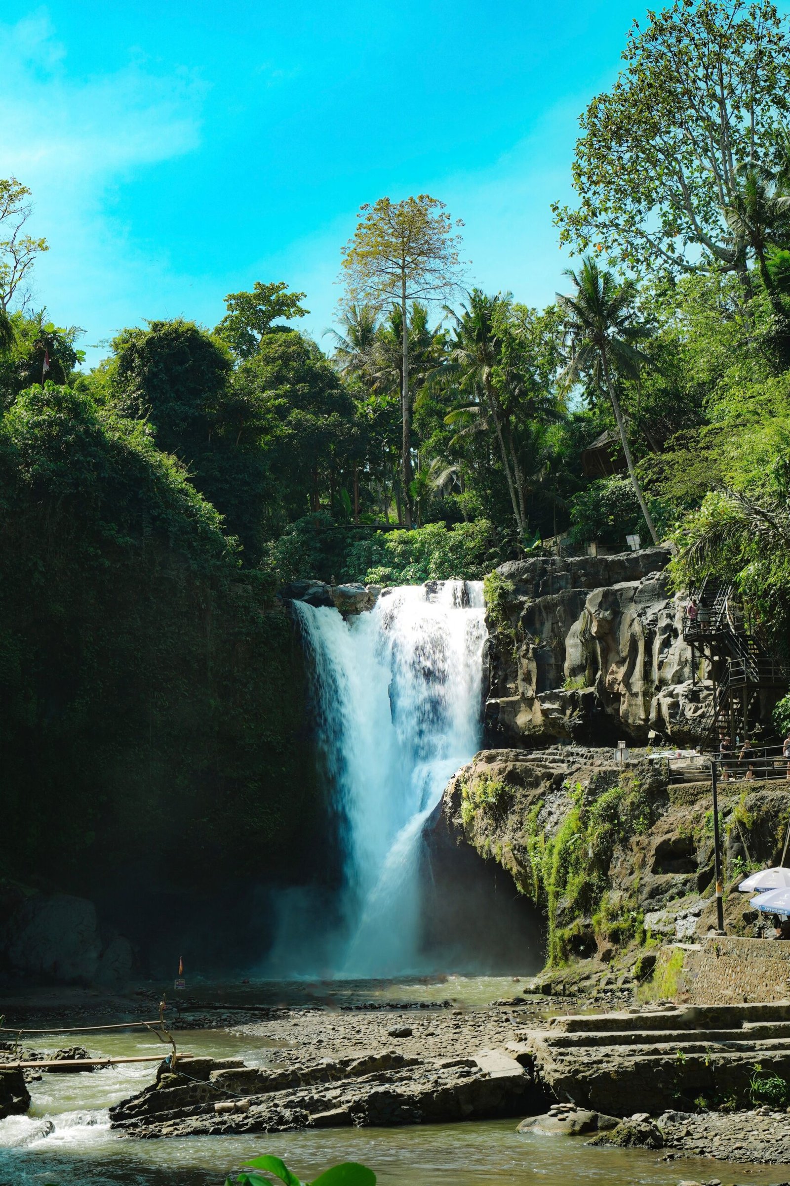 The Tegenungan waterfall falling through tropical forest near Ubud, Bali
